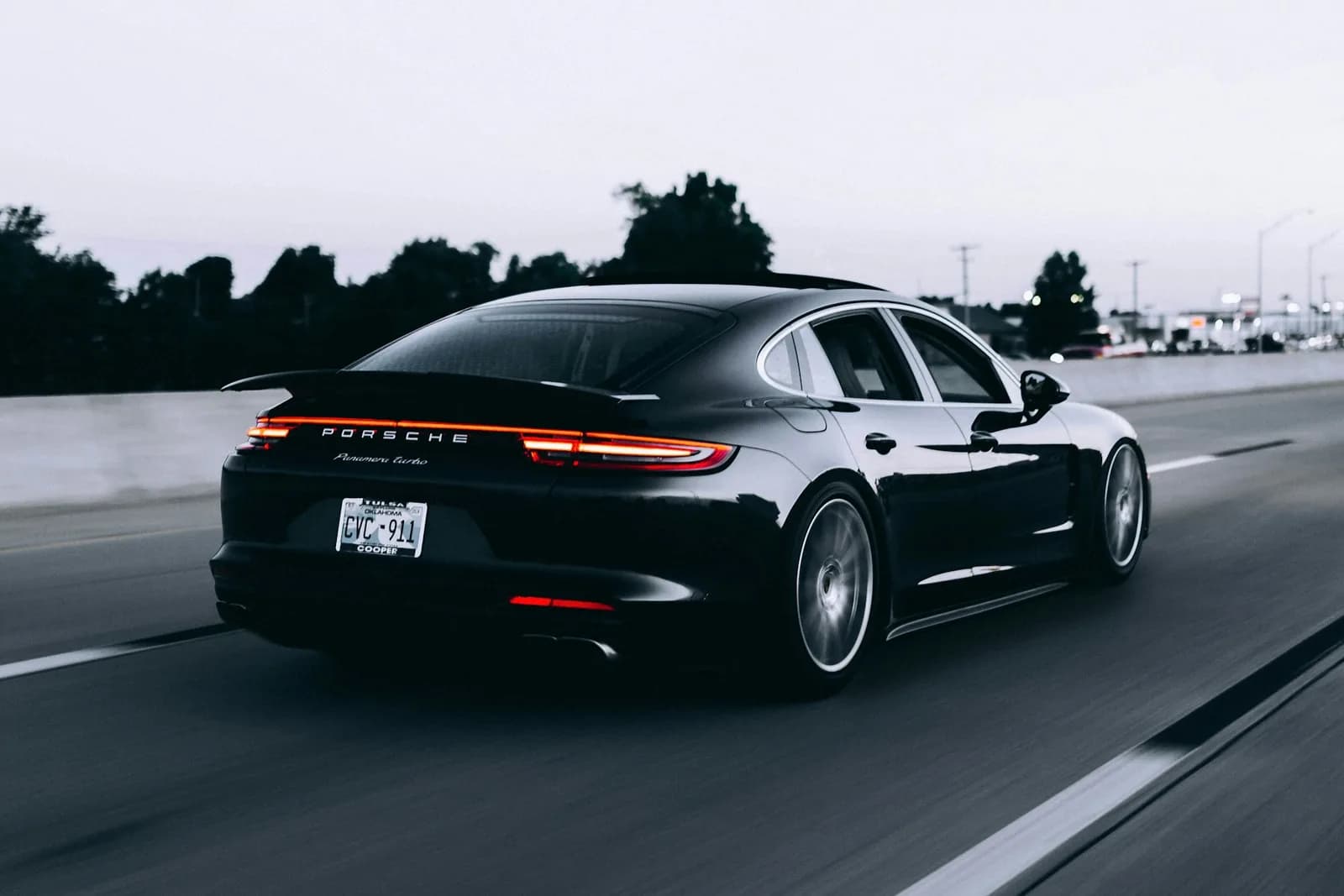Dark performance car photographed on a mountain road