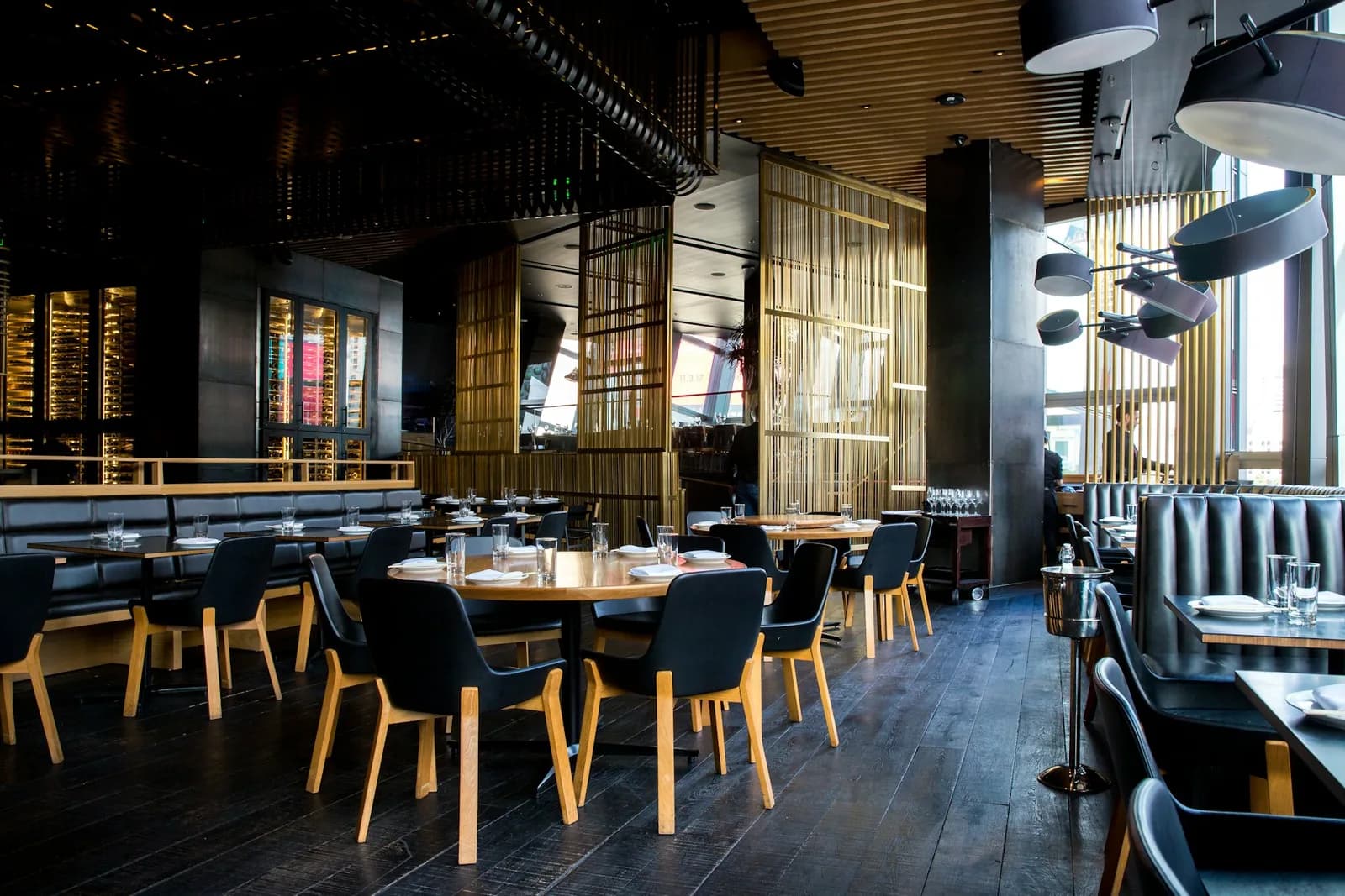 Warm restaurant interior with timber tables and intimate lighting